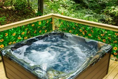 Steam rising, sunflowers glowing, forest all around — this private hot tub is where the drive melts off your shoulders. Sink in, tip your head back, and let the treetops do the rest.