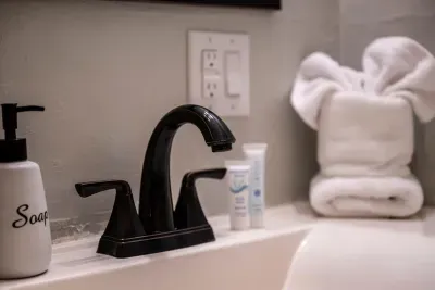 Plush towels folded and waiting, starter soap and shampoo stocked, and a shower with real water pressure. Small details, but they're why guests come back.