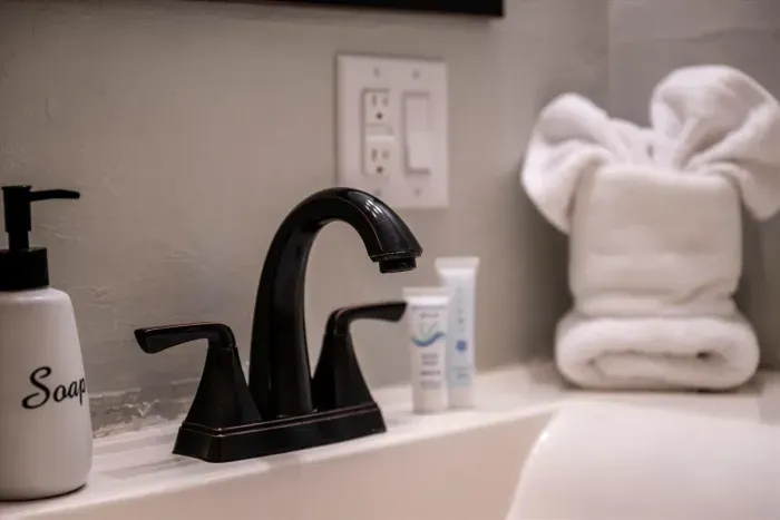 Plush towels folded and waiting, starter soap and shampoo stocked, and a shower with real water pressure. Small details, but they're why guests come back.