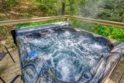 Private hot tub bubbling under the trees, jets on, steam curling into mountain air. Soak after the hike, soak before dinner, soak again just because you can.