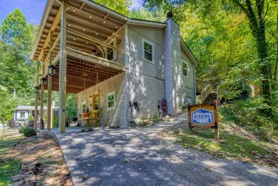Level gravel drive with covered parking right at the door — no hauling coolers uphill. Pull in, unload, and let the trees close in behind you. Truck and trailer friendly.