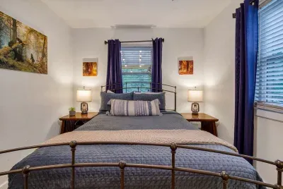 Handcrafted iron bed, blackout curtains, and a quiet that only mountain mornings deliver. Lamp-lit nightstands on both sides means nobody has to get up to flip the switch.