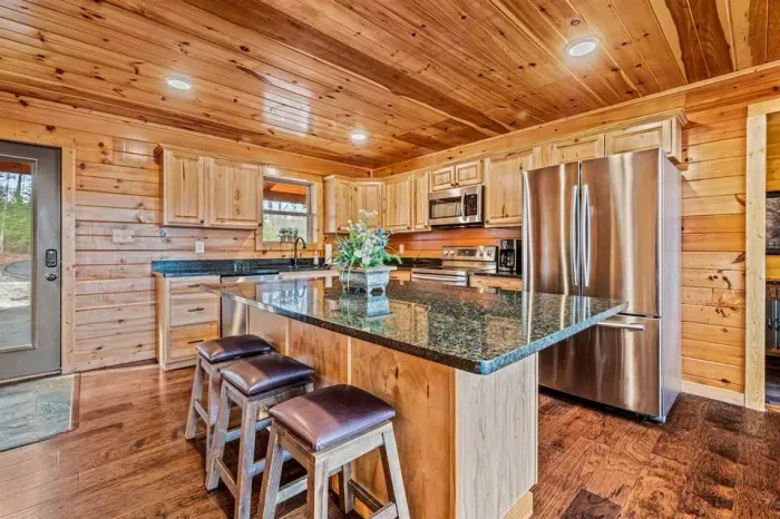 Your hub for culinary delights and cozy living—open kitchen with table and views
