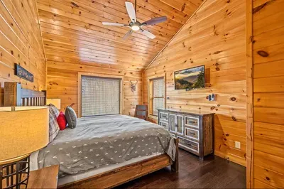 A cabin bedroom designed for comfort, rest, and tranquility