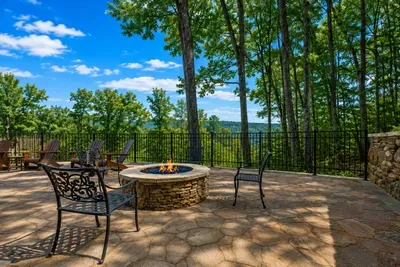 Warm flames, cool waters—relax by the poolside fireplace under the mountains ✨