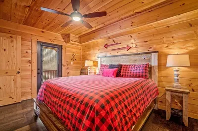 Wake up refreshed in a bedroom with bright red sheets, TV, and private bath.