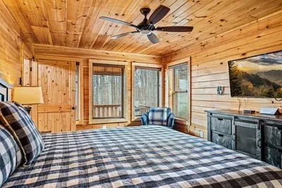 Relax in style—bedroom with TV, comfy sofa, and private bathroom