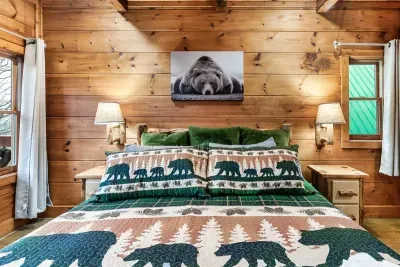 Upper level bedroom on the second floor features a king size bed, en suite bathroom, and door out to upper level deck and hot tub