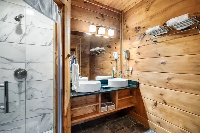En suite bathroom for upper level bedroom.  Newly updated shower!
