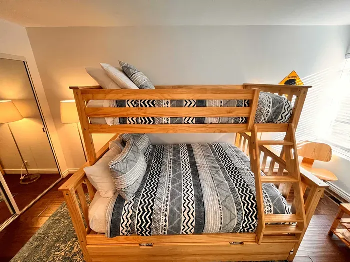 Guest bedroom 2 with a full sixed + Twin bunk bed and pullout mattress below.