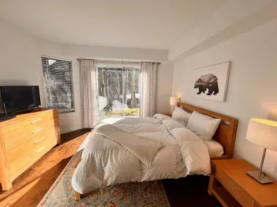 Guest Bedroom 1 with queen bed and slider door to back yard