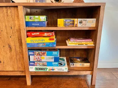 Boardgames, Puzzles and Books under loft stairs in living room