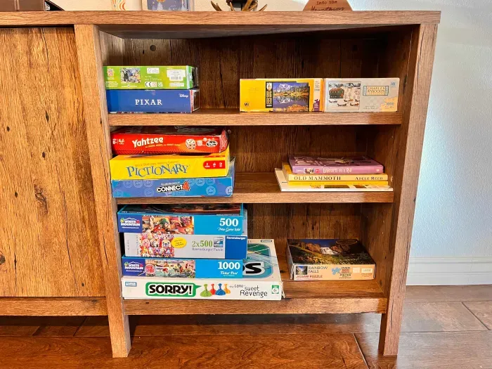 Boardgames, Puzzles and Books under loft stairs in living room