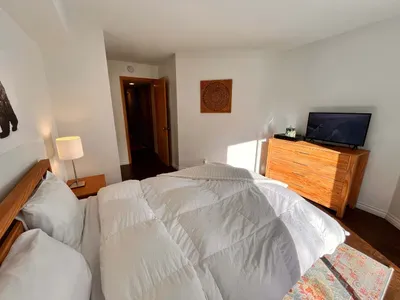 Guest Bedroom 1 with queen bed and slider door to back yard