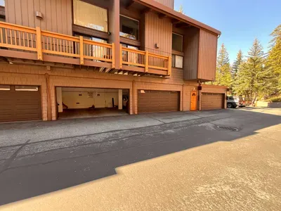 View of Garage Parking.  The designated parking spot for the condo is behind the open garage (third garage door from right side of building).