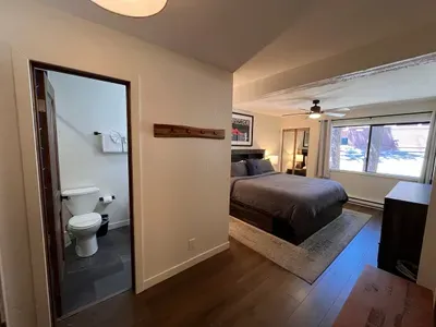 Bedroom with king sized memory foam bed, 40" smart TV, dresser, full closet and attached full bathroom.
