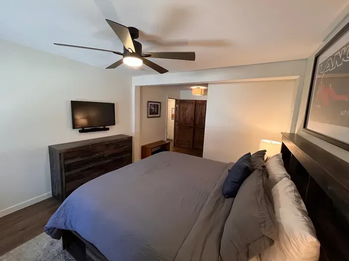 Bedroom with king sized memory foam bed, 40" smart TV, dresser, full closet and attached full bathroom.