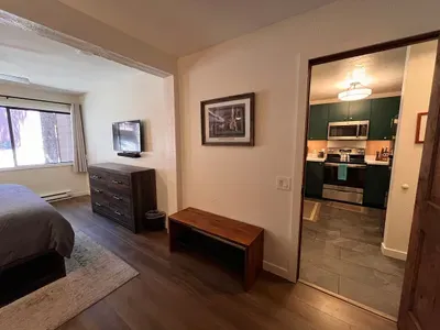 Bedroom with king sized memory foam bed, 40" smart TV, dresser, full closet and attached full bathroom.