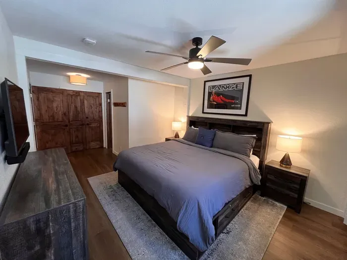 Bedroom with king sized memory foam bed, 40" smart TV, dresser, full closet and attached full bathroom.
