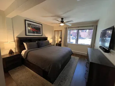 Bedroom with king sized memory foam bed, 40" smart TV, dresser, full closet and attached full bathroom.