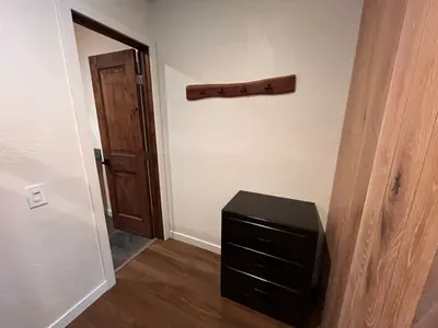 Bunkbed nook dresser and door to full bathroom