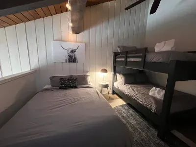 Loft sleeping area with a queen and full sized bunkbed. Includes a full sized closet with hangers at the end of the bunkbed. Loft has a door to separate it from the upstairs hallway but is open to the downstairs dining area.