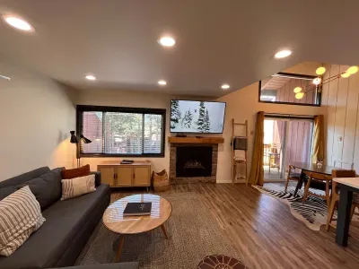 Living room with gas fireplace and 65" smrt TV.