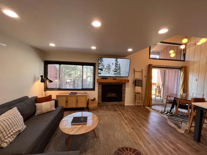 Living room with gas fireplace and 65" smrt TV.