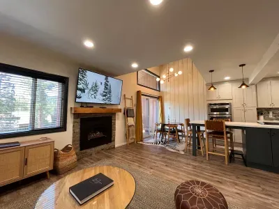 Living room with gas fireplace and 65" smrt TV.