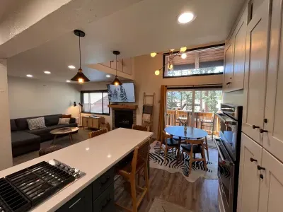 Living room dining area and private deck viewed from kitchen.