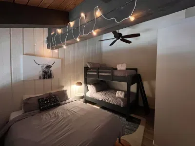 Loft sleeping area with a queen and full sized bunkbed. Includes a full sized closet with hangers at the end of the bunkbed. Loft has a door to separate it from the upstairs hallway but is open to the downstairs dining area.