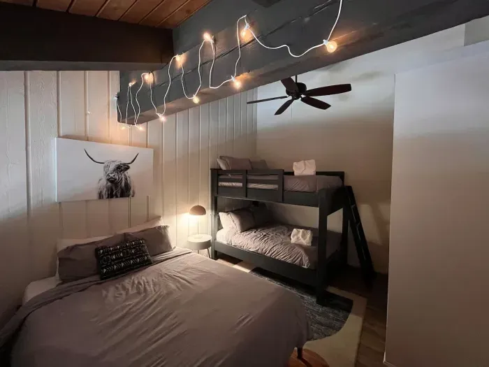 Loft sleeping area with a queen and full sized bunkbed. Includes a full sized closet with hangers at the end of the bunkbed. Loft has a door to separate it from the upstairs hallway but is open to the downstairs dining area.