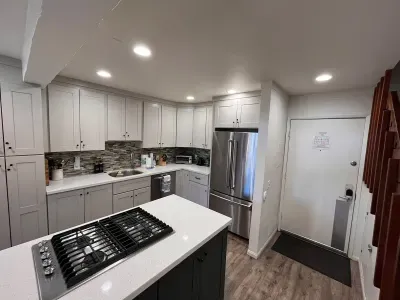 Full kitchen and front door to condo.
