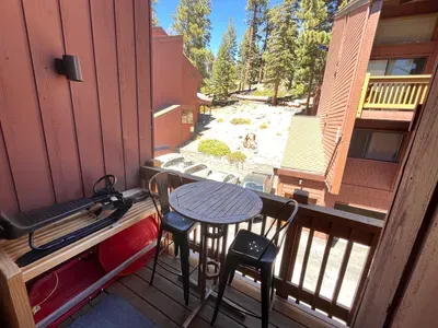 Private balcony with high top table and seating for 2
