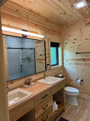 King size bed in the master bedroom suite with accompanying dual vanity bathroom and walk-in shower.
