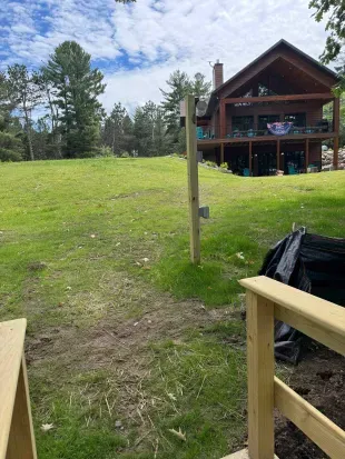 View of Lakeside #1 from the top of the stairs walking to the private swimming pool& boat dock.  Seen also is the convenient electric outlet for those needing to plug in boat battery chargers, etc.