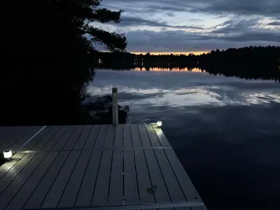 Sunset view across Little Round Lake from the private boat dock about 55 feet from the fire pit area outside the finished lower level of Lakeside #1.