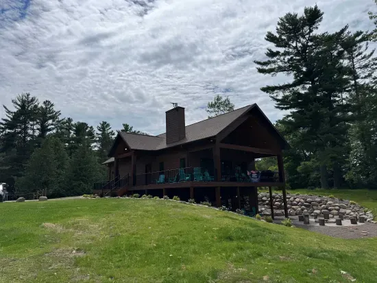 New build w/lake views from all levels! 3k+ sq.ft, 4bdrm / 3bath / twin beds (4) Sleeping Loft, ramp access, covered wrap-around deck, finished lower-level walk out to the fire-pit area and path to private boat dock, and views of sunrise and sunset.