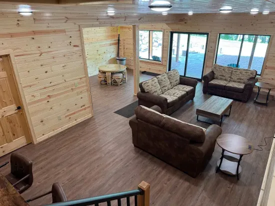 Lakeside #1 finished lower level entertaining area, 85" smart TV, 2nd kitchen, 4-person dining room& gaming table, 2 QB bedrooms, full bathroom #3, and walk out to fire pit area, private dock, & lake