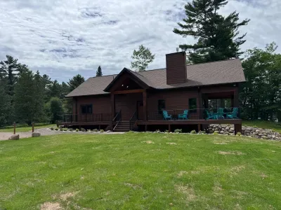 New build w/lake views from all levels! 3k+ sq.ft, 4bdrm / 3bath / twin beds (4) Sleeping Loft, ramp access, covered wrap-around deck, finished lower-level walk out to the fire-pit area and path to private boat dock, and views of sunrise and sunset.