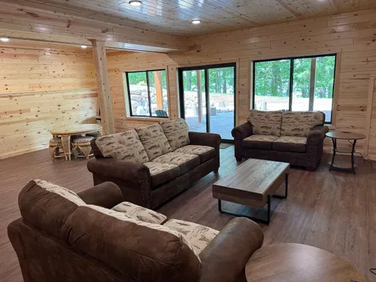 Lakeside #1 finished lower level entertaining area, 85" smart TV, 2nd kitchen, 4-person dining room& gaming table, 2 QB bedrooms, full bathroom #3, and walk out to fire pit area, private dock, & lake