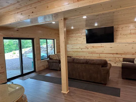 Lakeside #1 finished lower level entertaining area, 85" smart TV, 2nd kitchen, 4-person dining room& gaming table, 2 QB bedrooms, full bathroom #3, and walk out to fire pit area, private dock, & lake