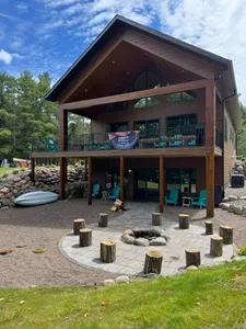 New build w/lake views from all levels! 3k+ sq.ft, 4bdrm / 3bath / twin beds (4) Sleeping Loft, ramp access, covered wrap-around deck, finished lower-level walk out to the fire-pit area and path to private boat dock, and views of sunrise and sunset.