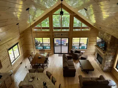 View from the 2nd story doorway into the closed sleeping loft within Lakeside #1 - view looking across open floor plan across the main level kitchen, great room, opening to the lakeside wrap around deck