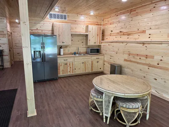 Lakeside #1 finished lower level 2nd kitchen, 4-person dining room& gaming table.  This is NOT a full kitchen, but is equipped with sink, refrigerator / freezer, and microwave.  Great for heating up pizza / making popcorn as all watch a game or movie