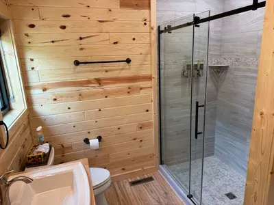 King size bed in the master bedroom suite with accompanying dual vanity bathroom and walk-in shower.
