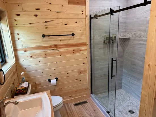 King size bed in the master bedroom suite with accompanying dual vanity bathroom and walk-in shower.