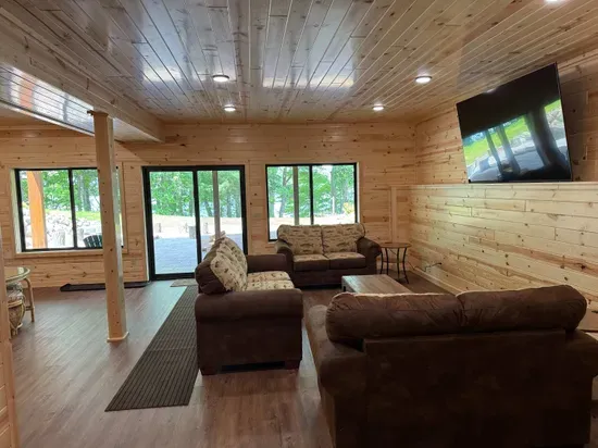Lakeside #1 finished lower level entertaining area, 85" smart TV, 2nd kitchen, 4-person dining room& gaming table, 2 QB bedrooms, full bathroom #3, and walk out to fire pit area, private dock, & lake