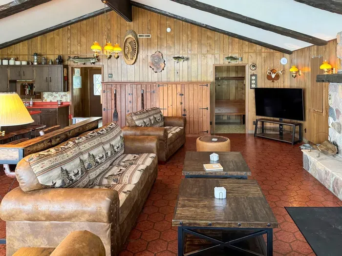 View from the lakeside windows looking across the great room living & entertainment area back towards the 2 entry points from the Lodge entry hallway