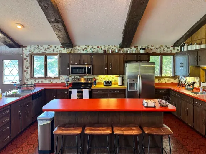 View of the full - well equipped kitchen and the center island eat-in seating for four, room for multiple cooks, and with visibility across the entire great room, dining, living room, entertainment space